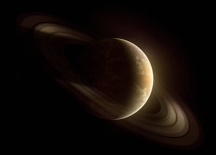 Ilustração representa o planeta Saturno, no fundo escuro do universo com seus anéis em destaque
