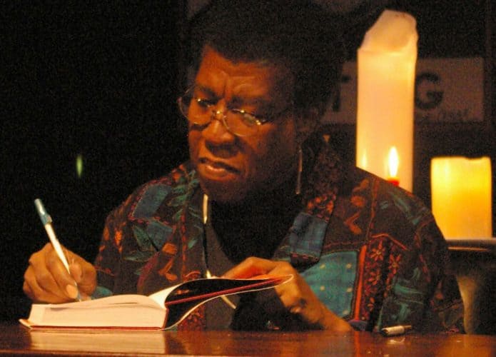 1280px-Octavia_Butler_signing-695x500