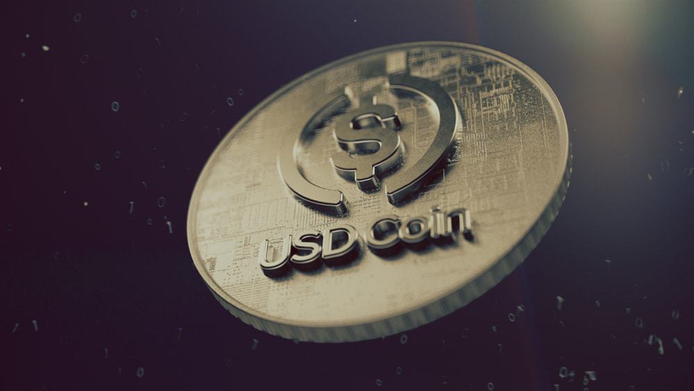 Imagem mostra uma moeda virtual e, no centro, dá para ler o nome USC Coin