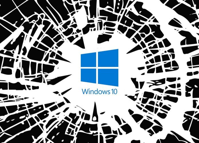 Imagem mostra um vidro estilhaçado com a logomarca do Windows 10 ao centro