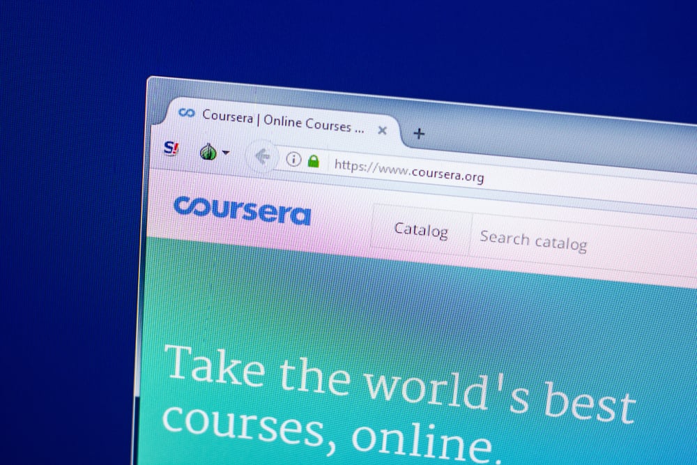 Imagem mostra o logo da startup Coursera, em uma página aberta em um navegador web. Na barra de endereços, é possível ver o site da edtech.