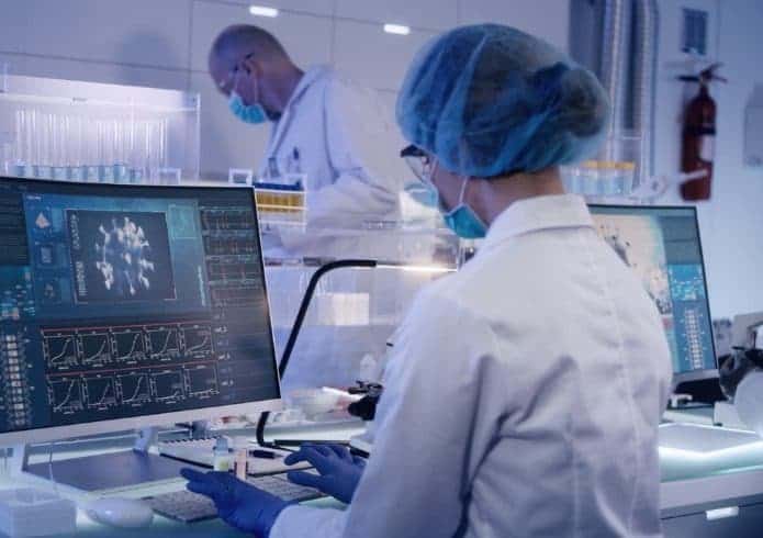 laboratory-team-working-on-coronavirus-vaccine-protective-workwear-picture-id1224413537-695x490