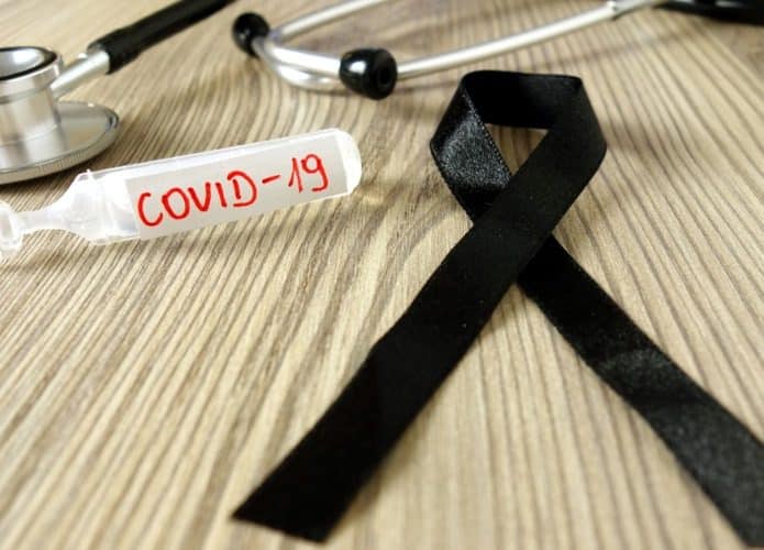 mourning-ribbon-ampoule-with-text-covid19-and-stethoscope-coronavirus-picture-id1214271047-695x500