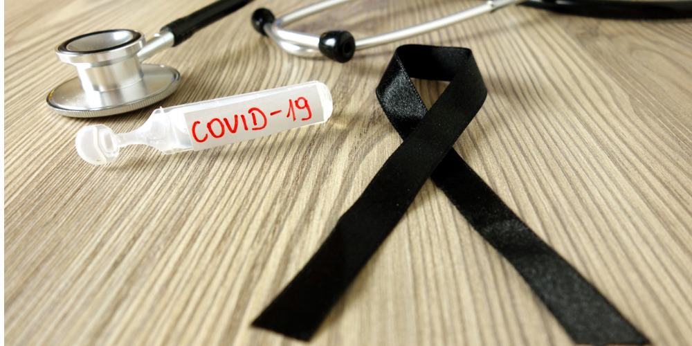 mourning-ribbon-ampoule-with-text-covid19-and-stethoscope-coronavirus-picture-id1214271047