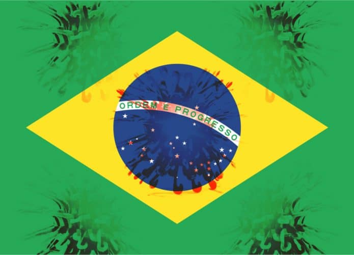 Imagem mostra a bandeira do Brasil com pequenos vírus a rodeando