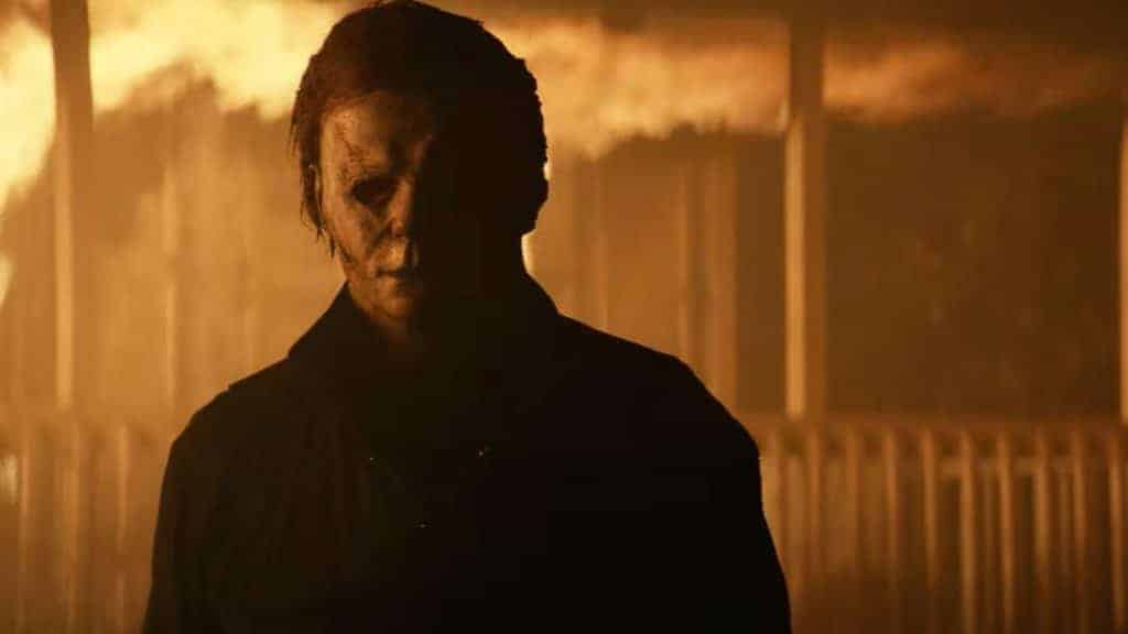 Imagem retirada do trailer de Halloween Kills exibe o assassino Michael Myers escapando de uma casa em chamas.