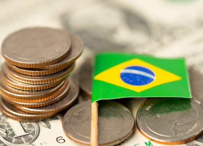 Ilustração de imposto ao lado de uma bandeira do Brasil