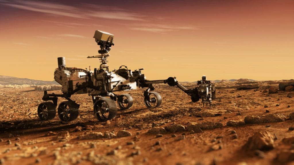 Imagem mostra renderização 3D do rover Perseverance em Marte, transitando pelo solo do planeta vermelho
