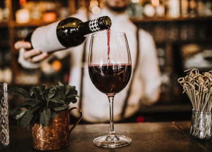 Barmen servindo vinho tinto