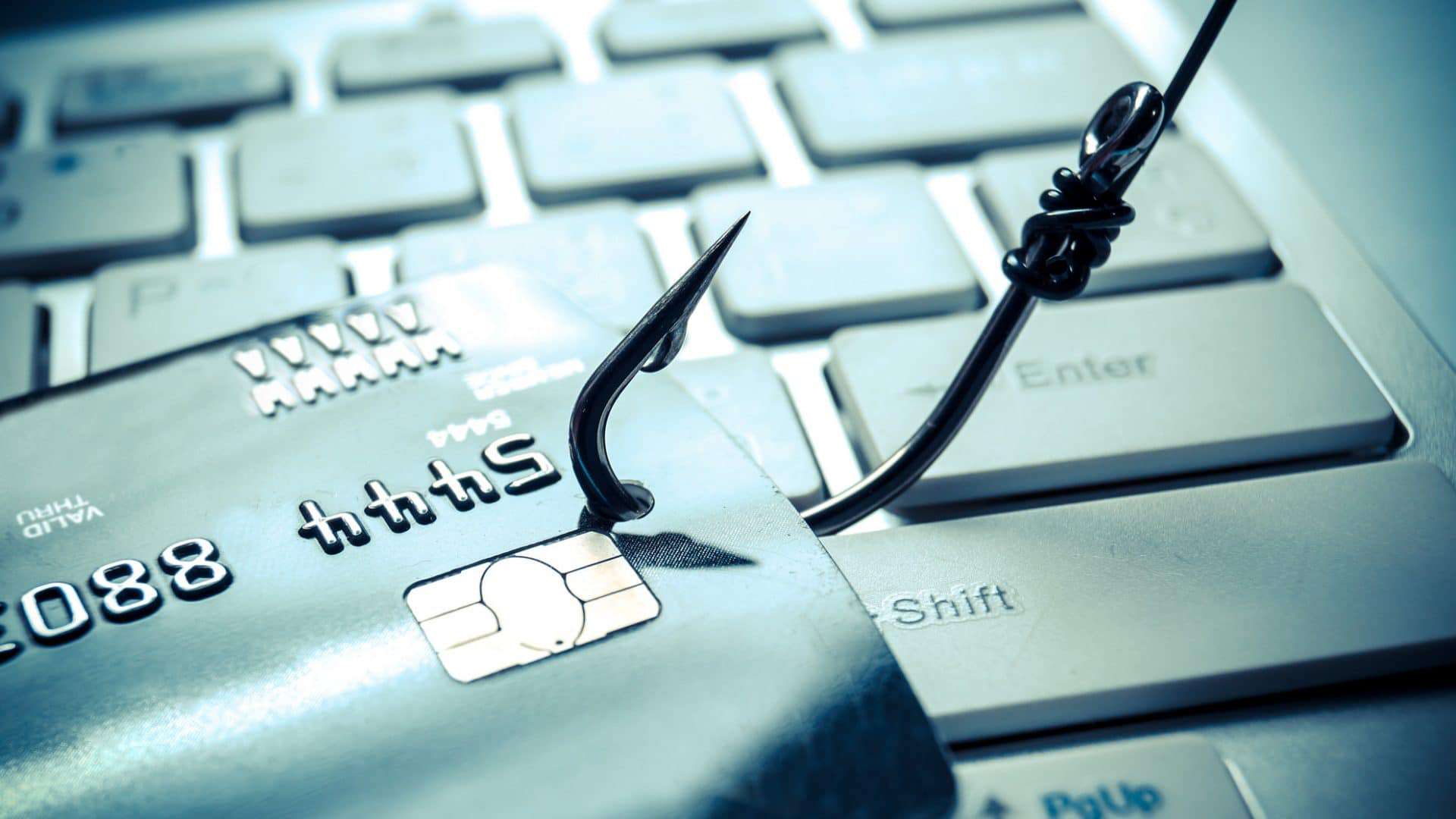 Anzol fisgando um cartão, ilustrando prejuízos do phishing