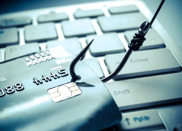 Anzol fisgando um cartão, ilustrando prejuízos do phishing