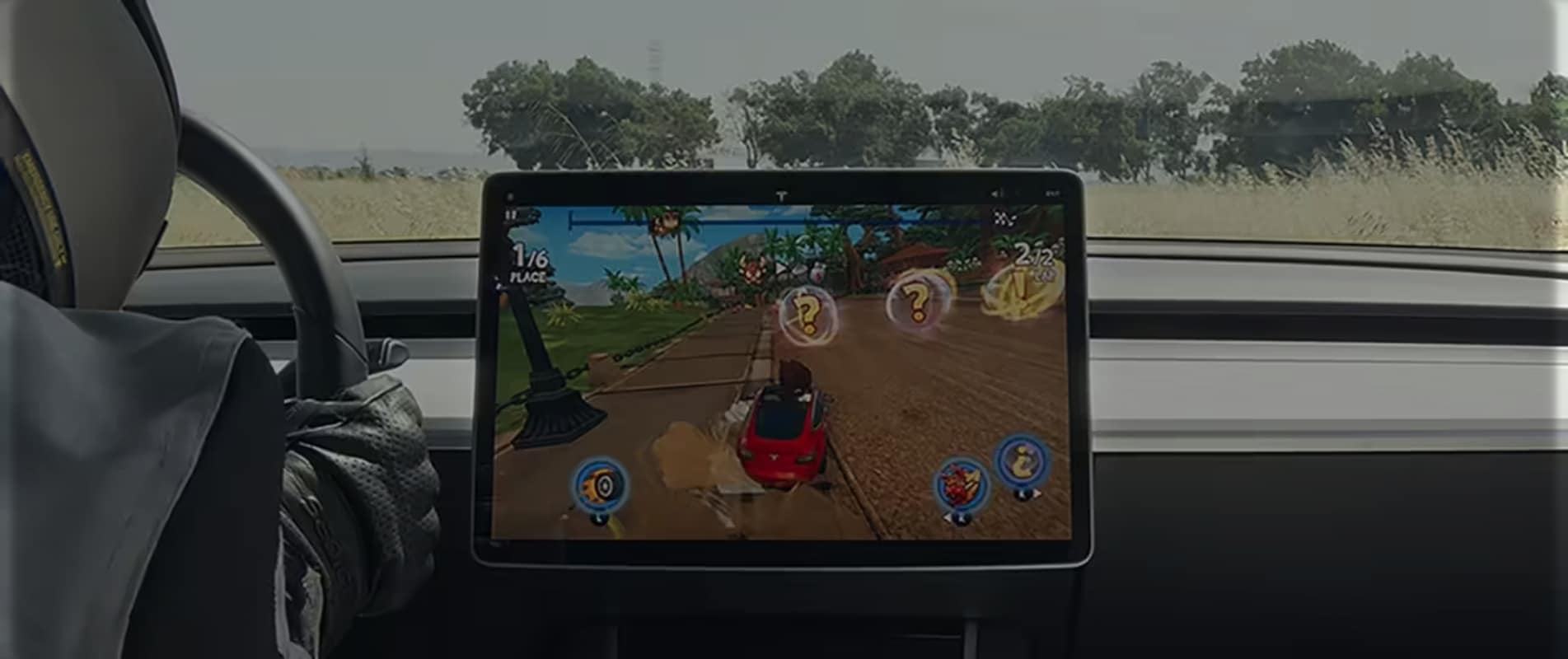 jogo de videogame em uma tela central na cabine de um carro da Tesla e com o motorista dirigindo