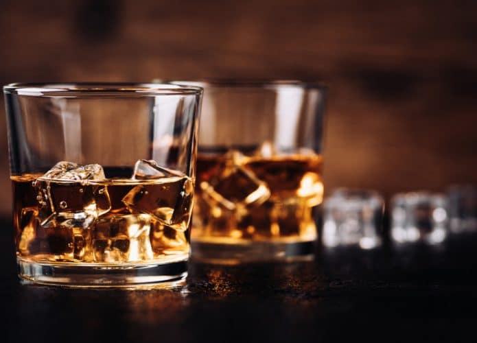 Whisky,,Bourbon,Or,Cognac,With,Ice,Cubes,On,Black,Stone