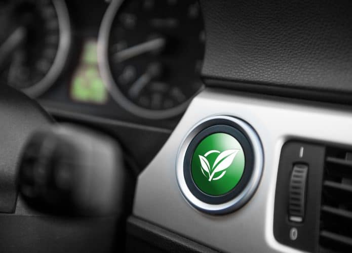Green ECO mode button on a dashboard of a sportive car - para ilustrar carros a hidrogênio e a bateria, elétrico