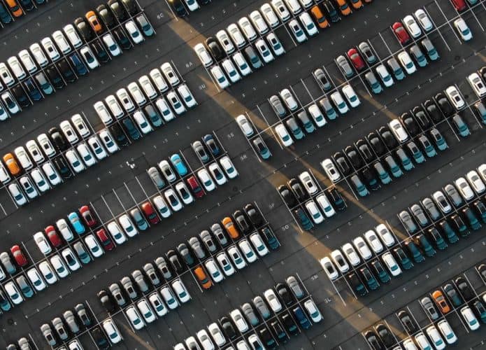 Inúmeros veículos em um estacionamento para ilustrar uma quantidade muito grande de fabricantes que deixaram de trabalhar com a Rússia