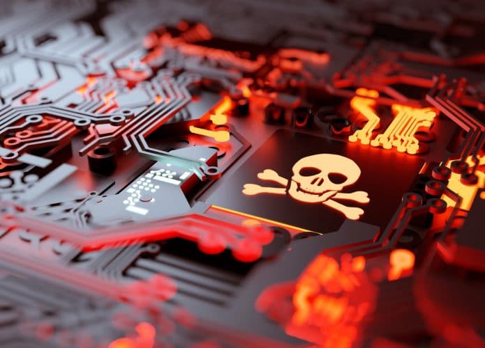 Ilustração de um sistema corrompido (com uma imagem de caveiria em um processador) remetendo a um ataque ransomware