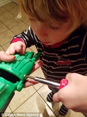 Cameron is pictured putting together a 3D hand
