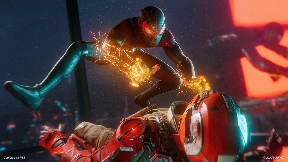 Spider-Man shocking an enemy lying on the ground in Spider-Man: Miles Morales