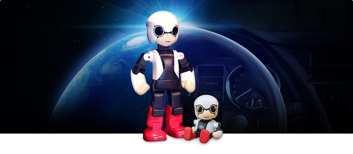 Kirobo and Kirobo Mini in front of steering wheel