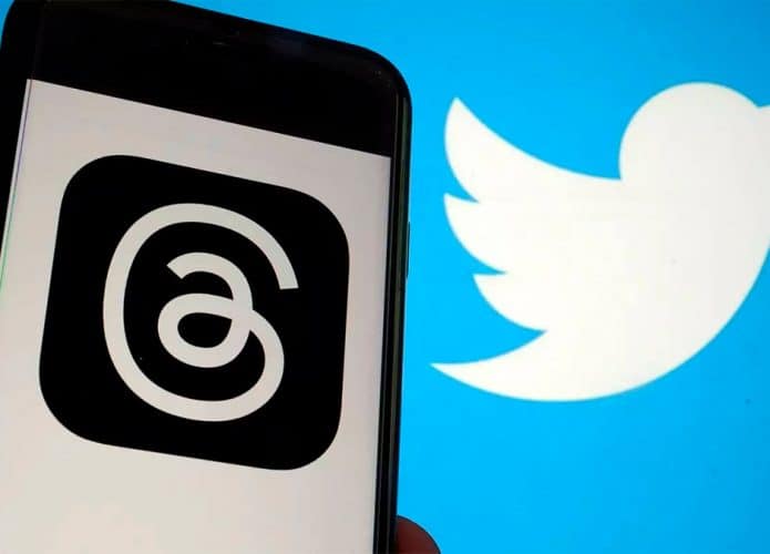 Celular com logomarca do Threads e, ao. fundo, imagem com logomarca do Twitter