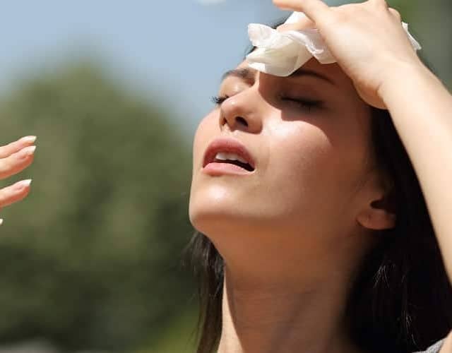 Stressed,Asian,Woman,Drying,Sweat,With,A,Cloth,In,A