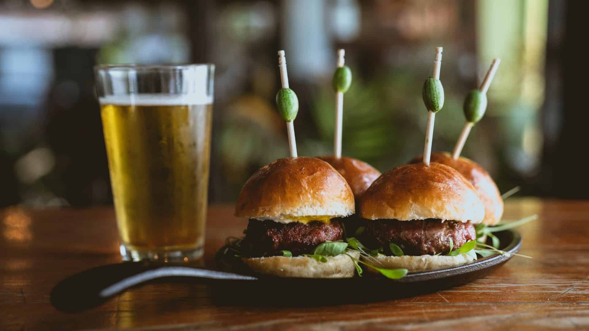 Cerveja e hamburguer, para ilustrar o risco de câncer que trazem alguns alimentos