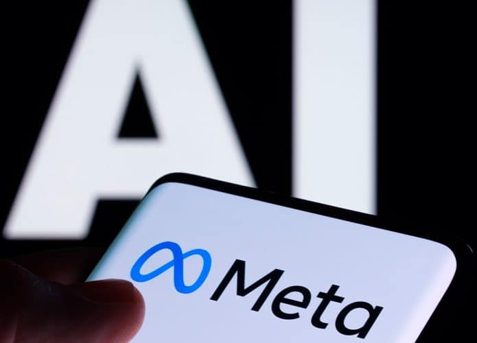 Pessoa tocando em tela de celular com logomarca da Meta e, ao fundo, está escrito AI, a sigla em inglês para inteligência artificial