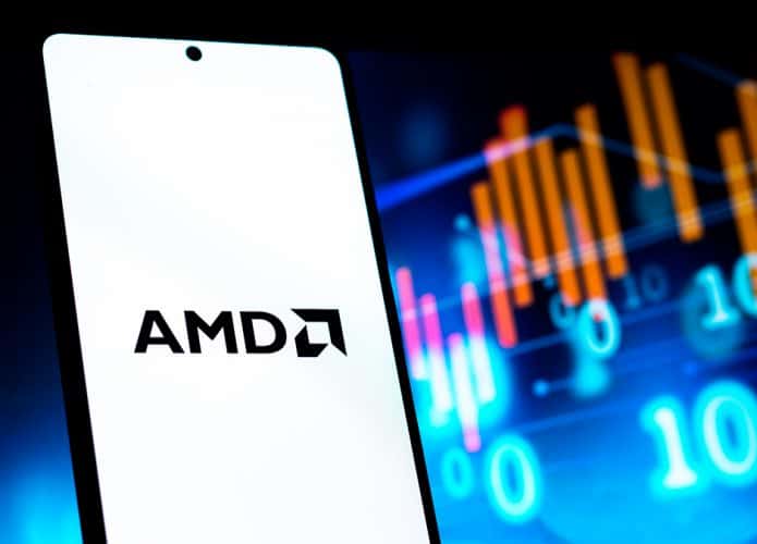 Celular com logotipo da AMD na tela e linhas de ações financeiras ao fundo