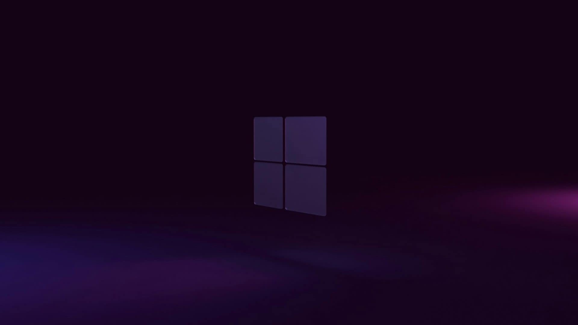 papel de parede com a logo do windows 11 num fundo escuro