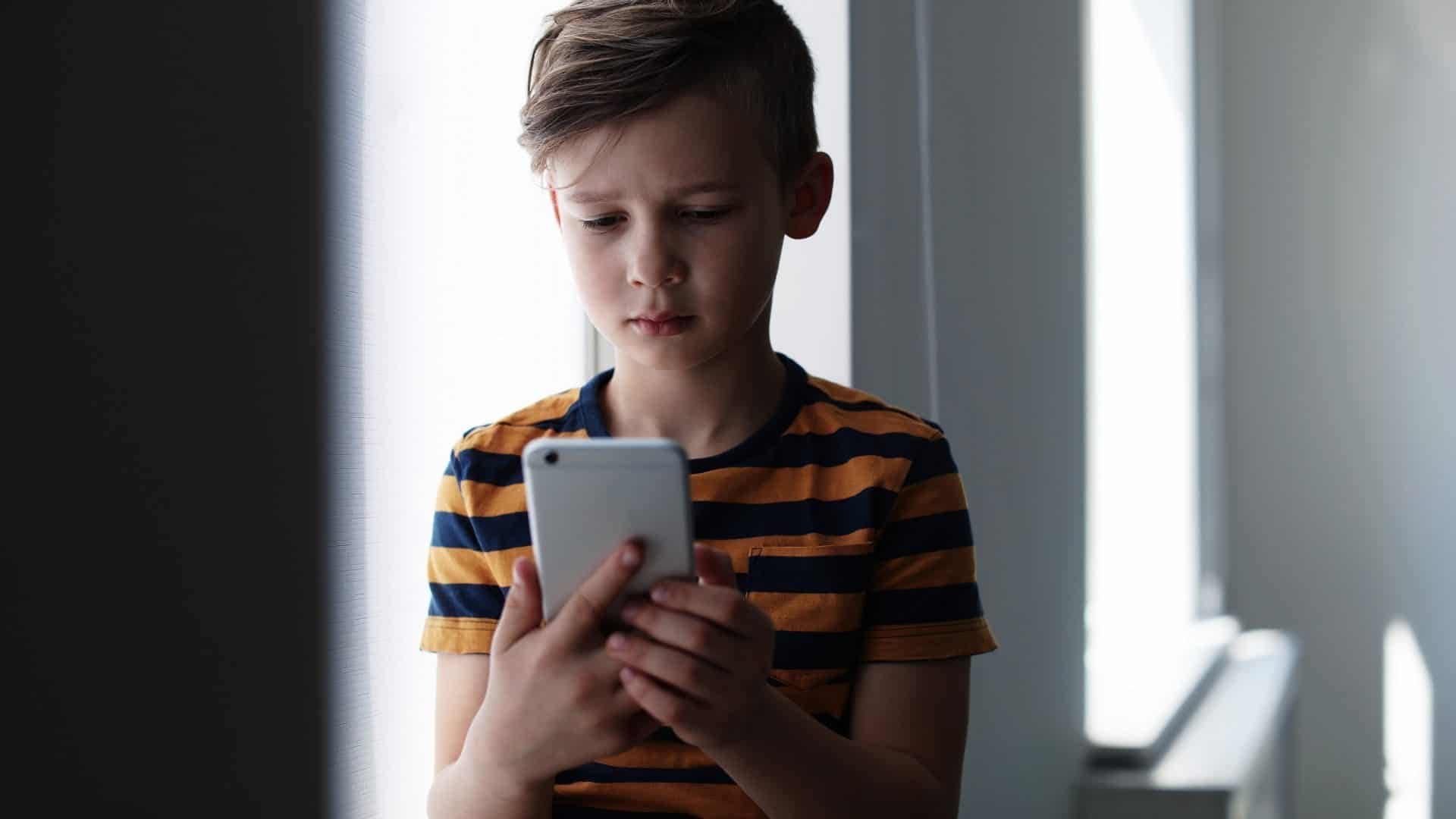 criança usando smartphone