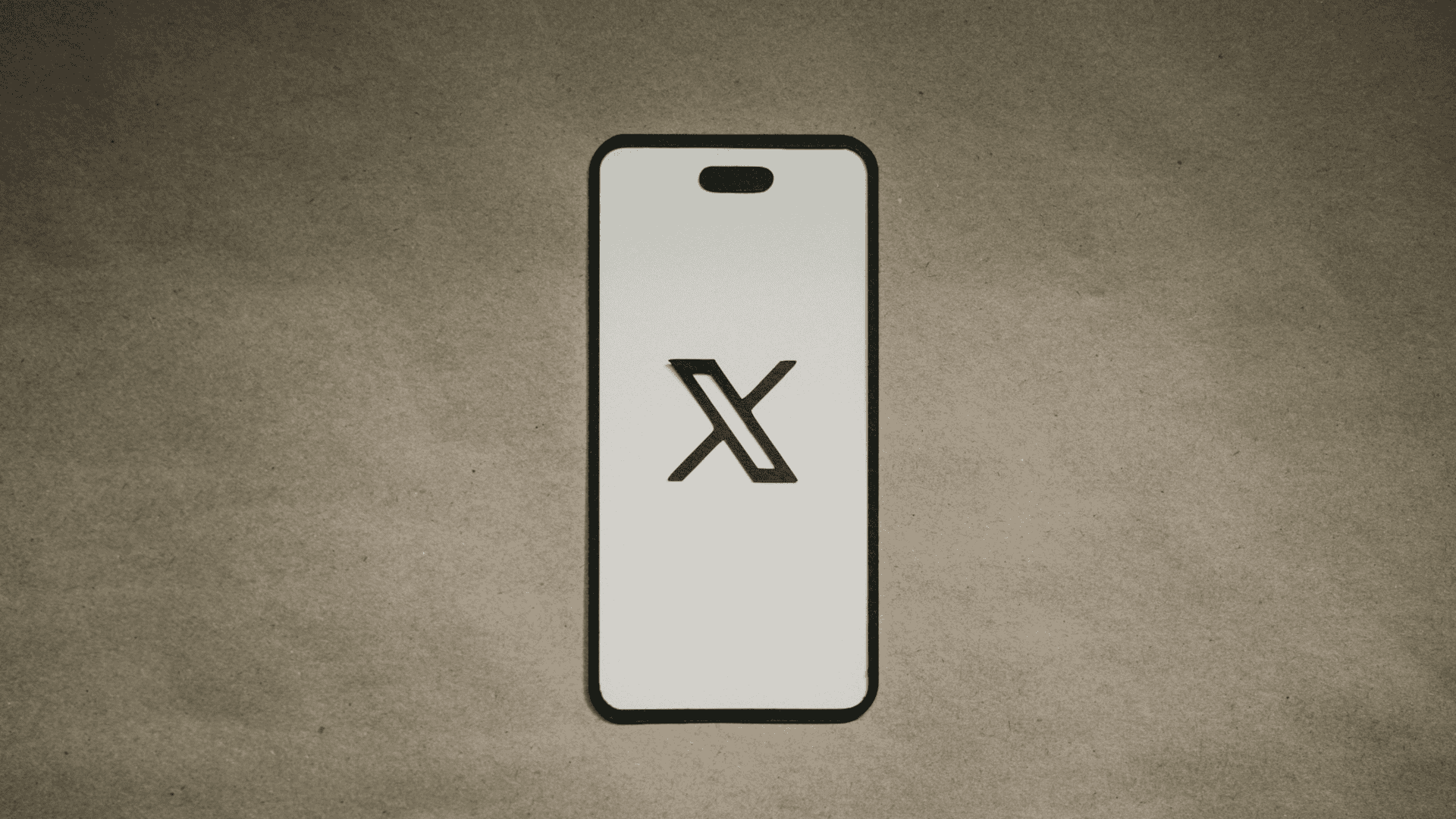 imagem mostra um celular com a tela completamente preenchida pelo ícone da rede social X/Twitter