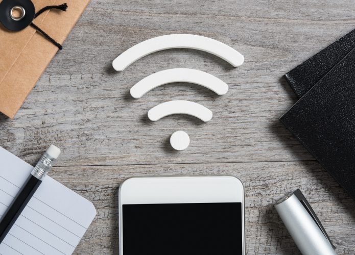 Vista superior do smartphone na mesa procura uma conexão wi-fi