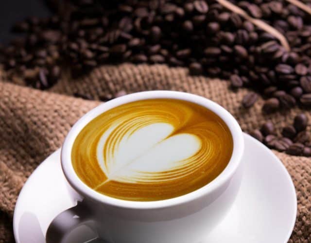 Cup,Of,Coffee,Latte,With,Heart,Shape,And,Coffee,Beans