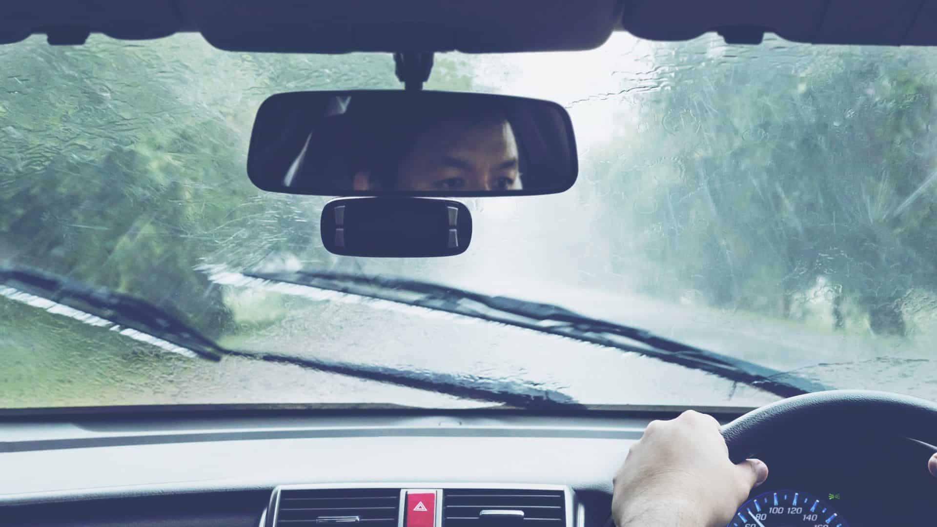 Man driving car in heavy rainfall