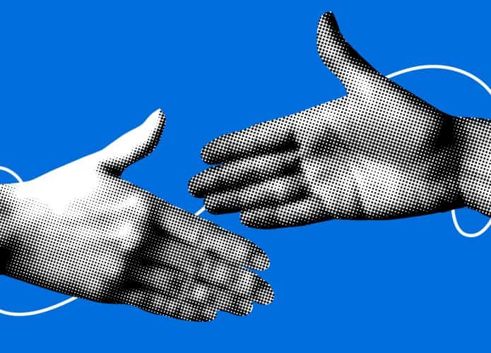 Duas mãos humanas prestes a se cumprimentarem