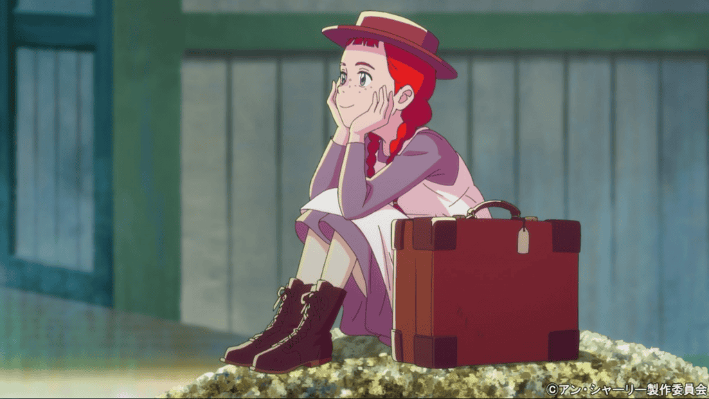 personagem ruiva, com tranças e usando chapéu, com uma mala ao lado