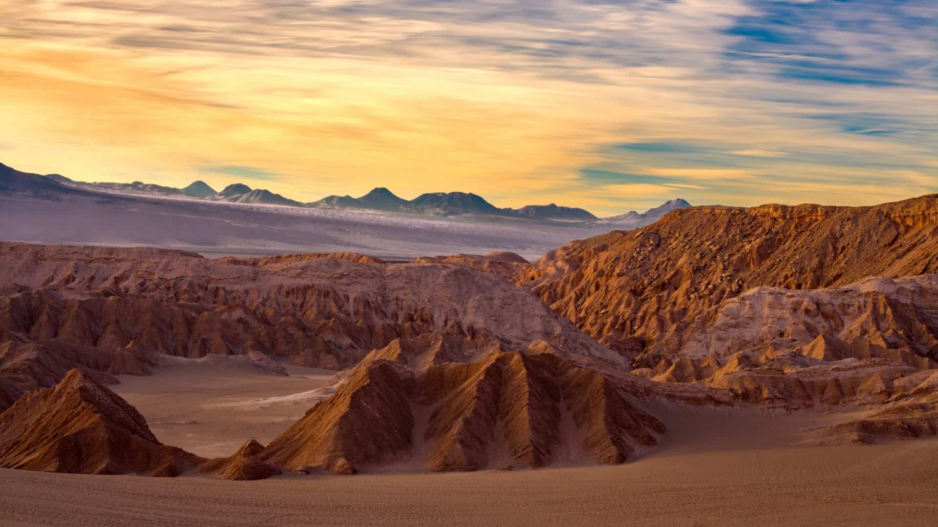 Nascer do sol iluminando as formações de sal e dunas de areia no Valle de la Muerte, perto de San Pedro de Atacama, no deserto do Atacama, Chile