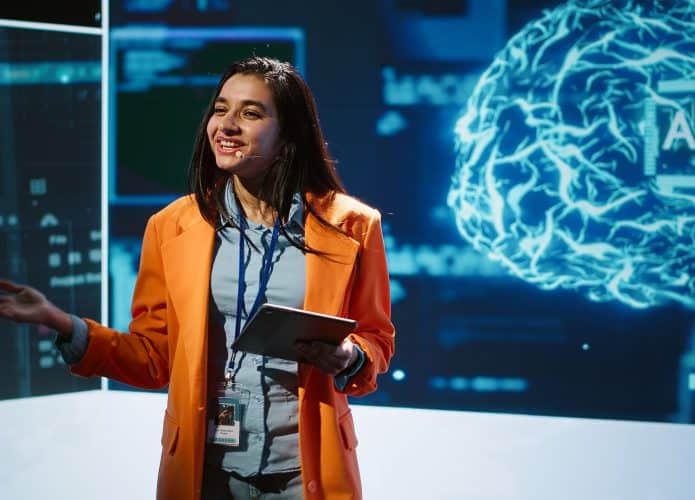 Happy speaker doing presentation at tech conference, explore ways emerging AI technologies can positively enhance companies workforce. Presenter promoting artificial intelligence solutions, camera A
