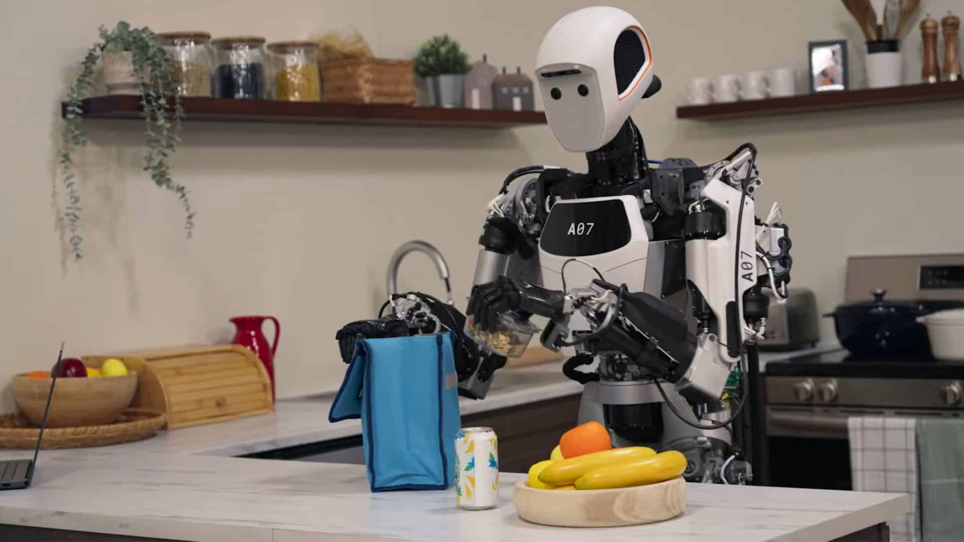 Robô com modelos de IA Gemini Robotics, do Google DeepMind, numa cozinha colocando itens numa lancheira