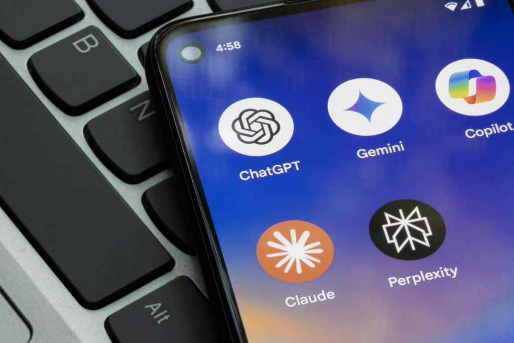 Logos de apps de quatro IAs em um smartphone