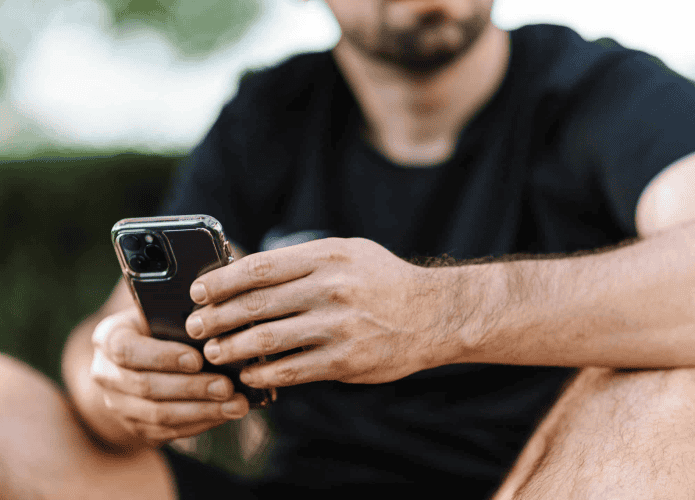 Homem testando configurações no iPhone