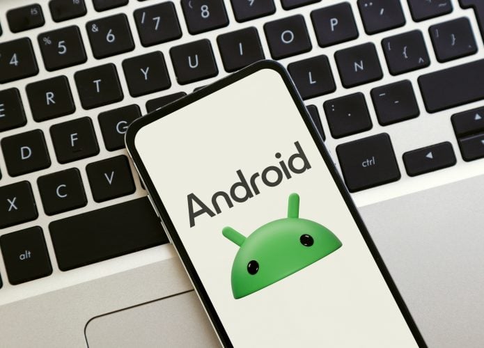 Logotipo do Android na tela do celular. Um smartphone sobre um laptop exibindo o novo logotipo do Android