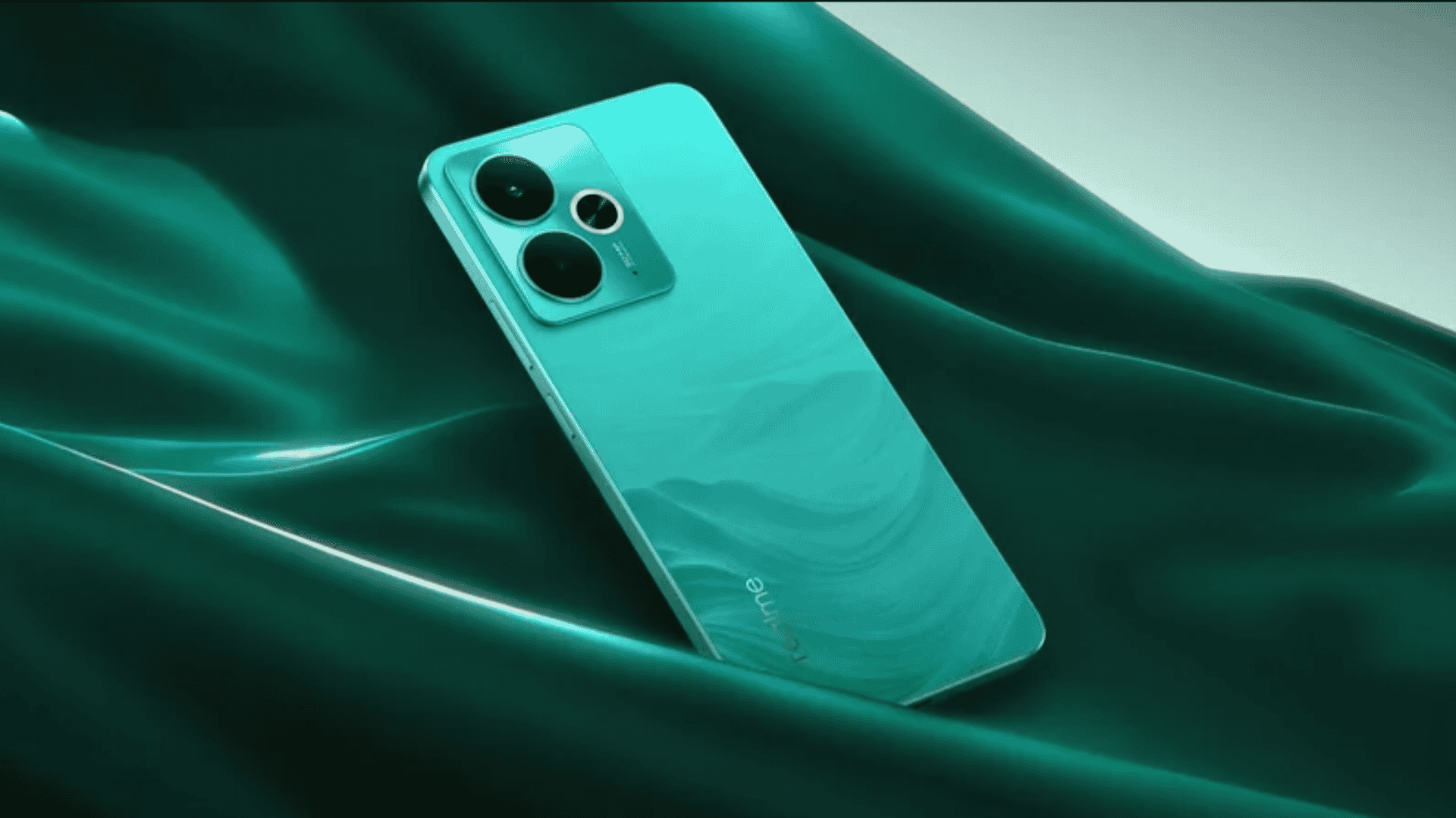 imagem mostra um celular verde sobre as ondas tridimensionais de um tecido verde
