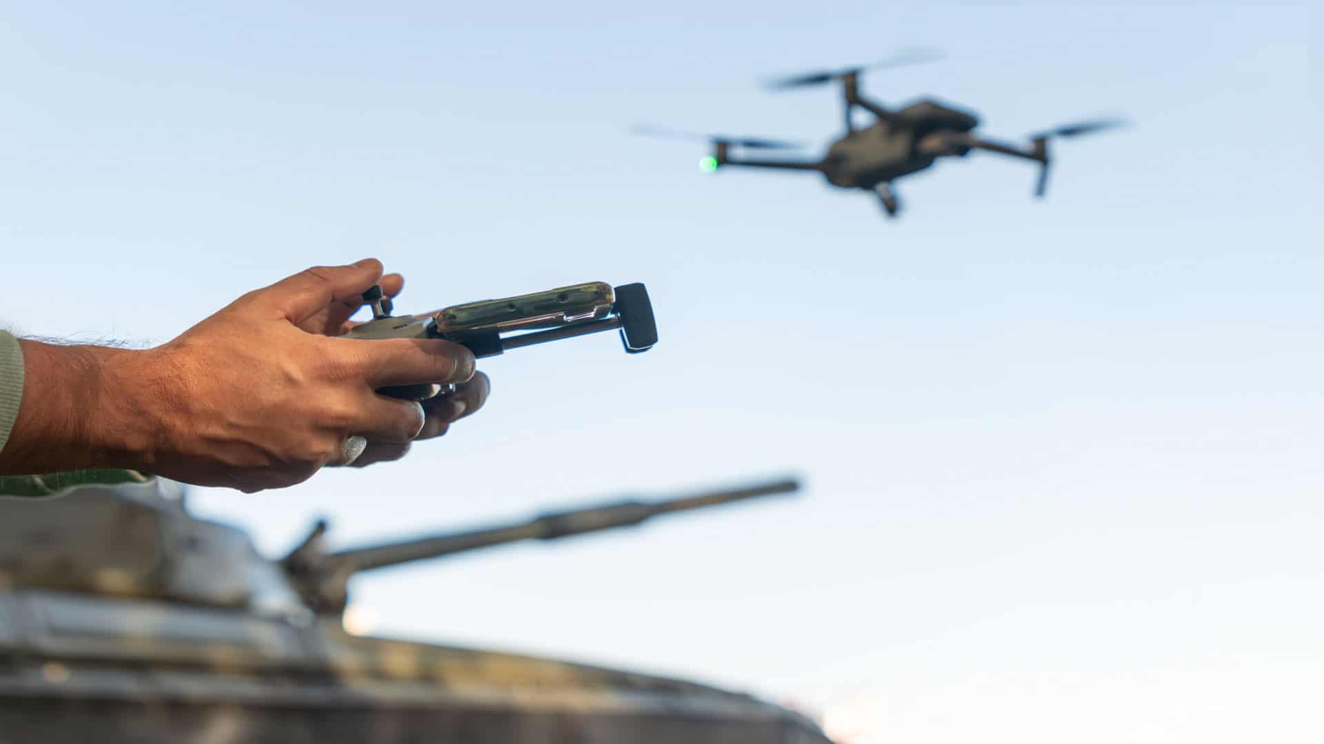 Imagem mostra mãos de militar controlando um drone