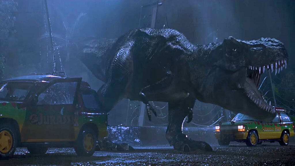 T-Rex rugindo em cena do filme Jurassic Park