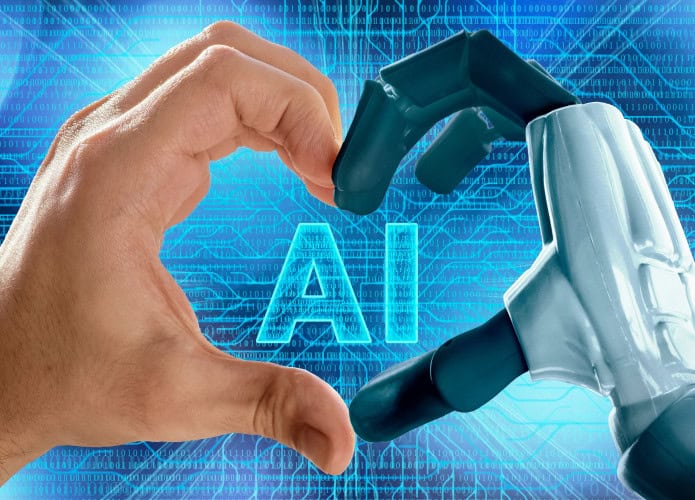 Mão humana e braço robótico formando um coração — conceito de amor, inteligência artificial e bate-papo virtual. / Crédito: TSViPhoto (Shutterstock)