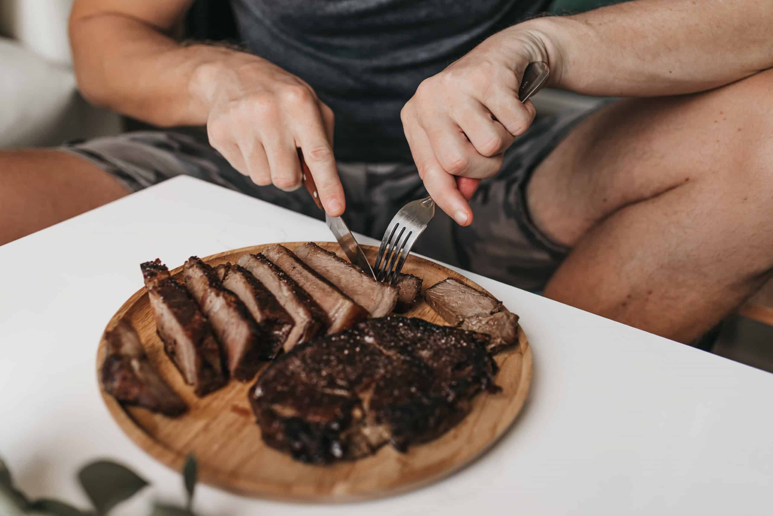 Homem comendo churrasco