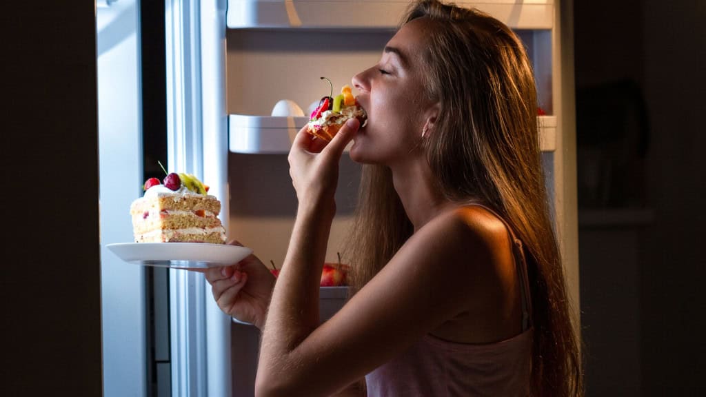 Mulher comendo bolo tarde da noite 