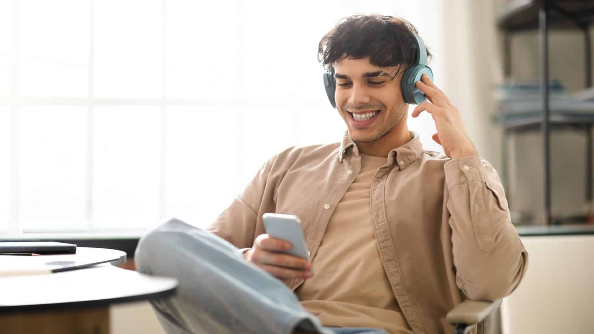 Homem ouvindo música pelo celular
