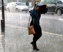 Pessoa com uma bolsa em cima da cabeça durante chuva
